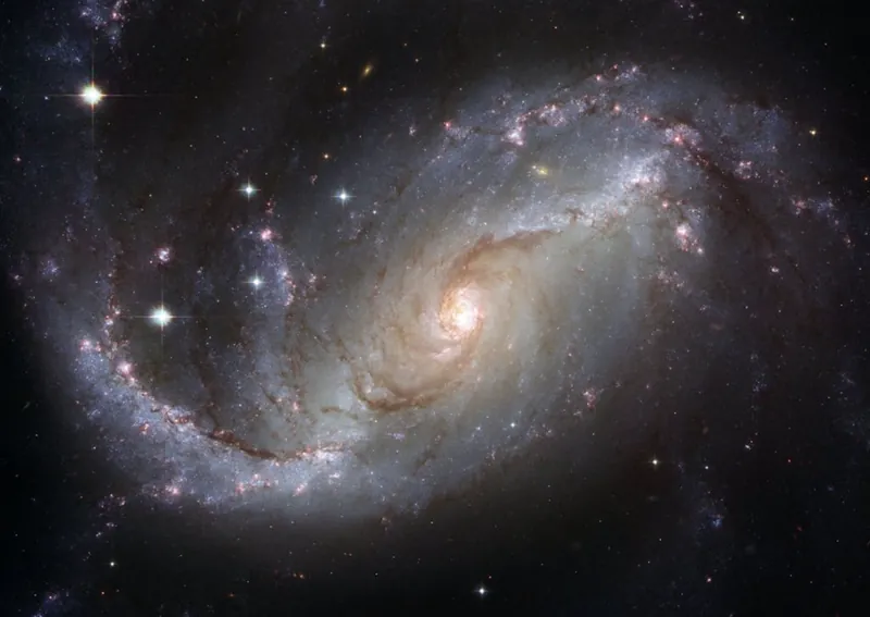 A picture of deep space, with many stars and a nebula in the background