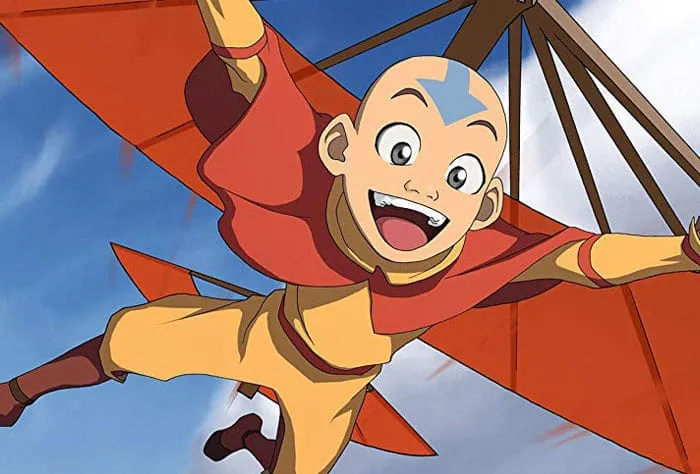 Aang soars on a glider in the sky